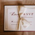 invitation card with the inscription tied with ribbon